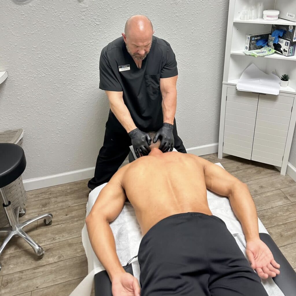Pete Belcastro, LMT, performing deep tissue massage on athletic client at The Athlete Massage in Tampa Bay